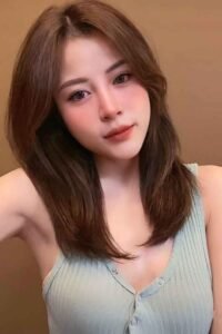 Attractive young woman with shoulder-length brown hair.