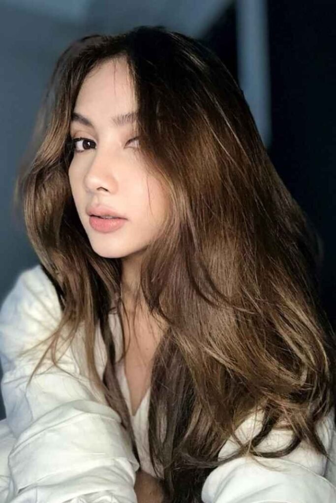 Portrait of a young woman with long brown hair.